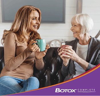 Two women holding coffee mugs
